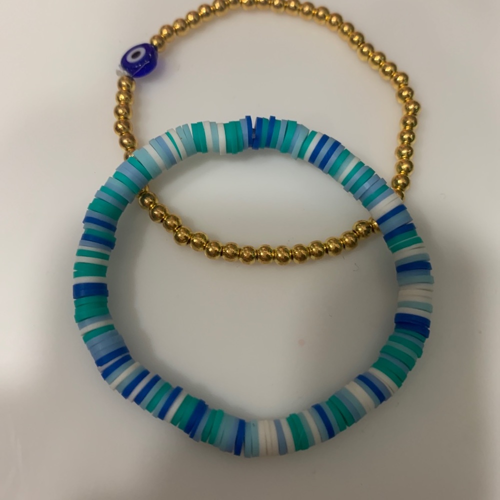 1x blue bloom bracelet 1x gold evil eye bracelet FOR SALE may not say that!!!